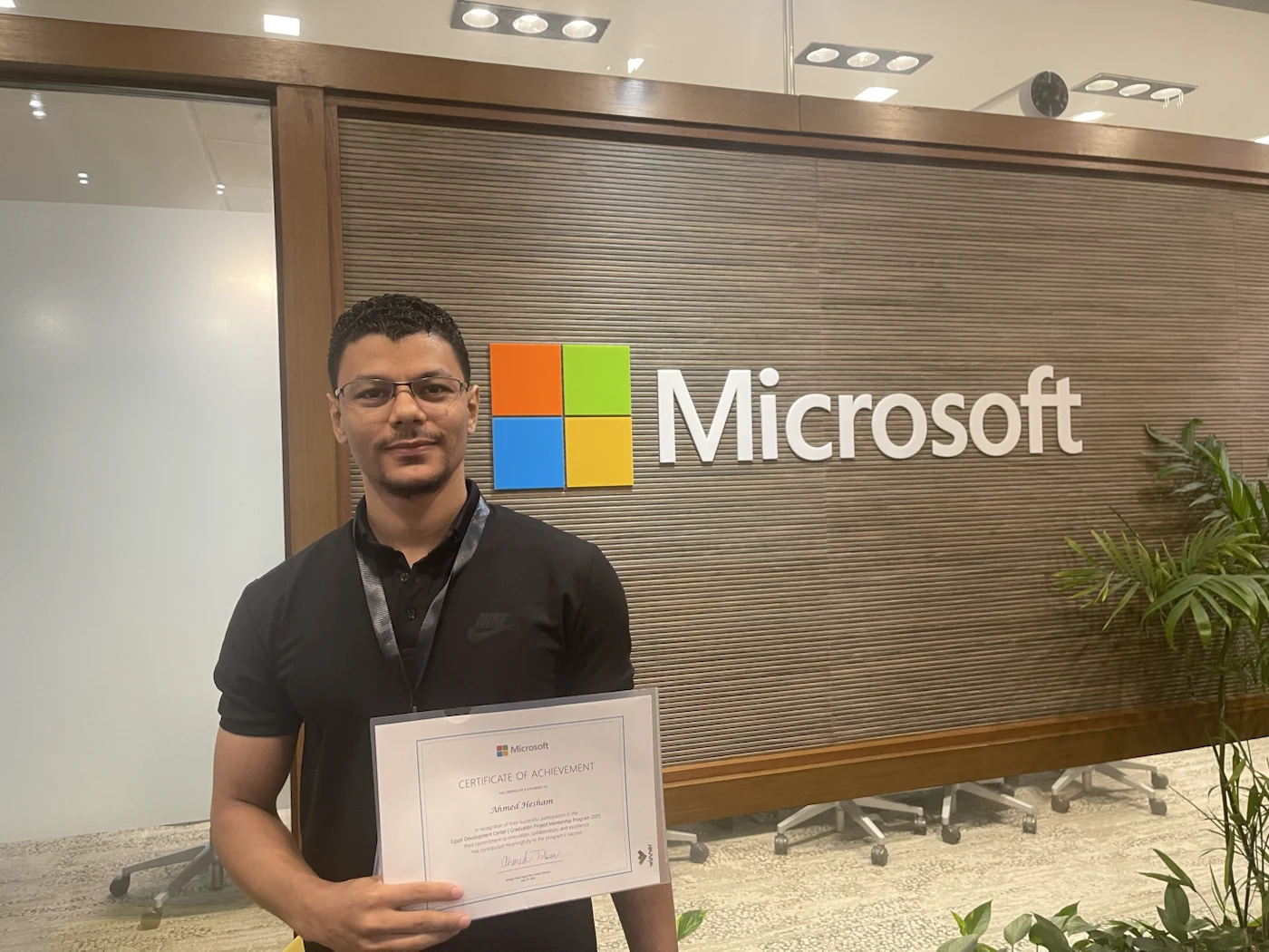Ahmed holding his Microsoft graduation project mentorship programme certificate